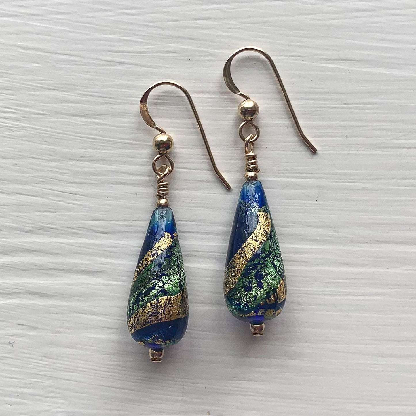 Diana Ingram earrings with dark blue, teal and gold Murano glass short pear drops on Sterling Silver or 22 Carat gold vermeil hooks